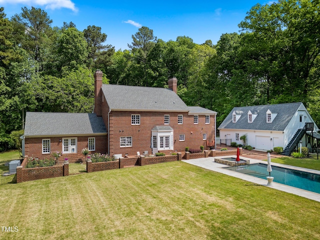 back of house with french doors, a yard, and a chimney