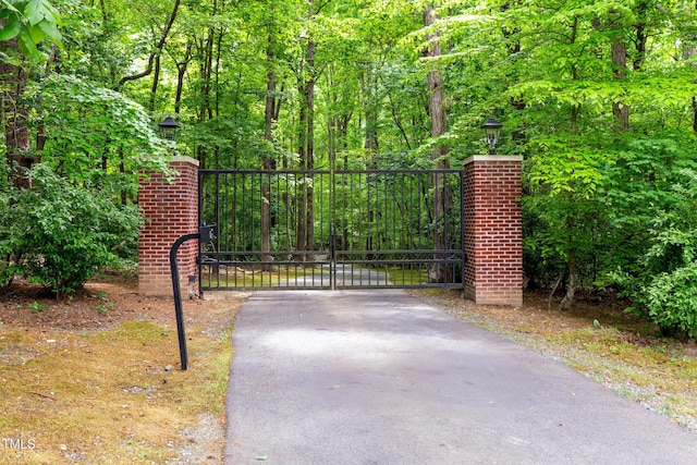 view of gate featuring a forest view