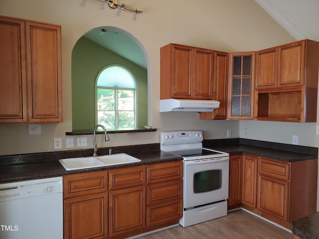 725 Van Thomas Dr, Raleigh, NC 27615 - kitchen with white appliances, under cabinet range hood, a sink, lofted ceiling, and brown cabinetry