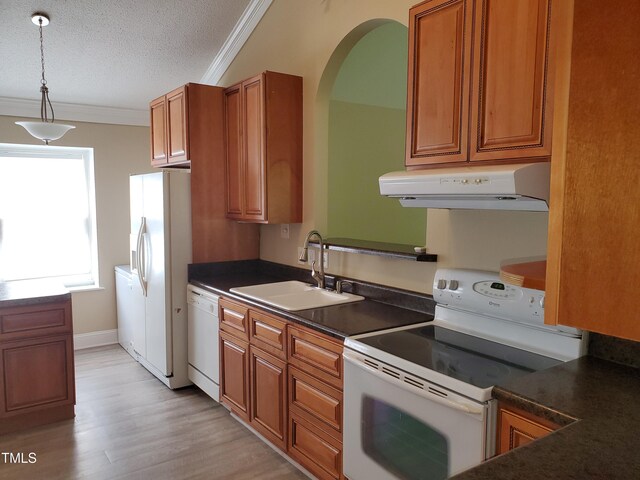 725 Van Thomas Dr, Raleigh, NC 27615 - kitchen featuring white appliances, under cabinet range hood, a sink, dark countertops, and brown cabinets