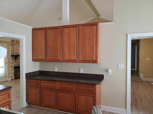 725 Van Thomas Dr, Raleigh, NC 27615 - kitchen featuring light wood-style floors, dark countertops, and brown cabinetry