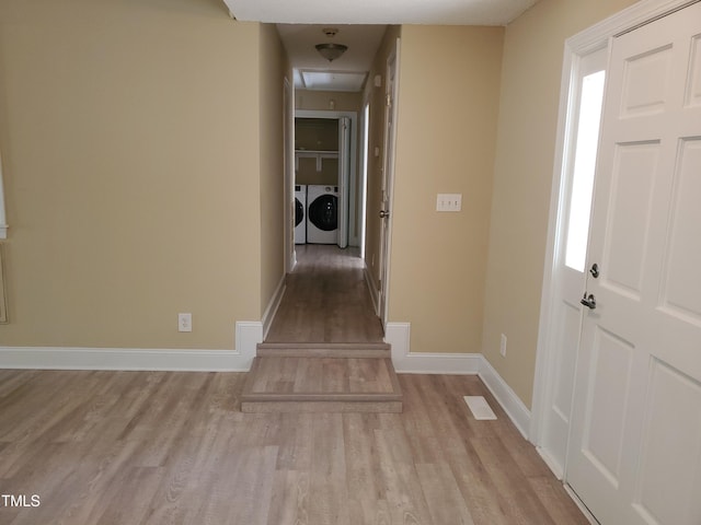 725 Van Thomas Dr, Raleigh, NC 27615 - foyer entrance with wood finished floors, washing machine and clothes dryer, and baseboards