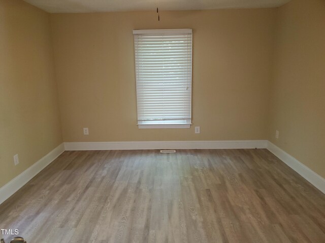 725 Van Thomas Dr, Raleigh, NC 27615 - unfurnished room with wood finished floors, plenty of natural light, and baseboards