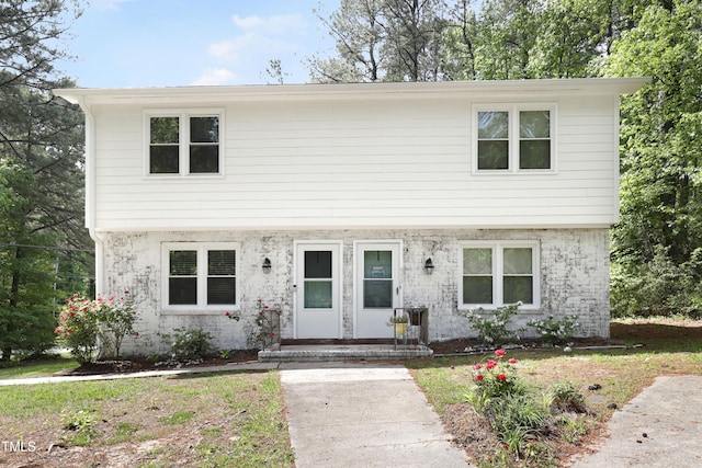 colonial inspired home with brick siding