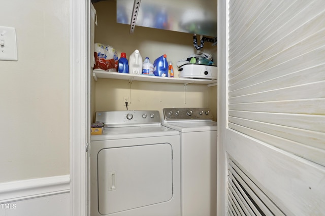 clothes washing area with laundry area and washer and clothes dryer