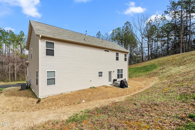 rear view of house with central air condition unit