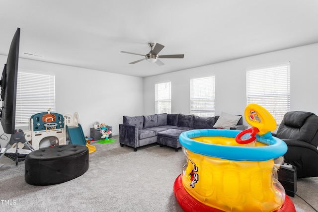 recreation room featuring a ceiling fan and carpet flooring