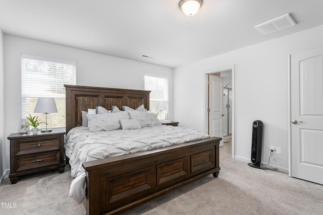 bedroom featuring light colored carpet, visible vents, connected bathroom, and baseboards