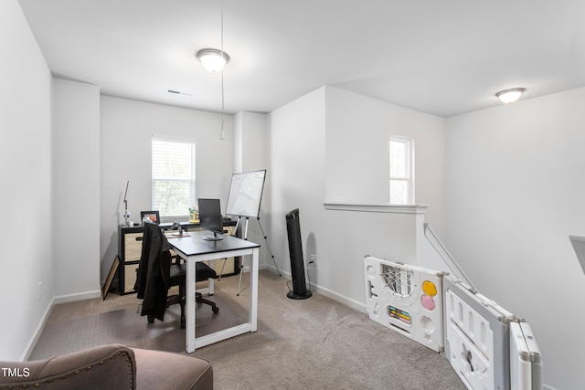 carpeted home office featuring baseboards and visible vents