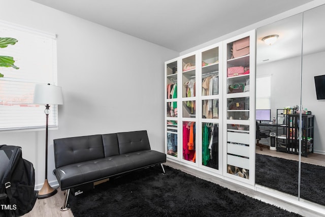 living area featuring wood finished floors and baseboards