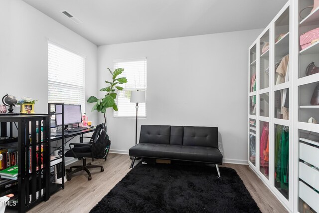 office with visible vents, wood finished floors, and baseboards