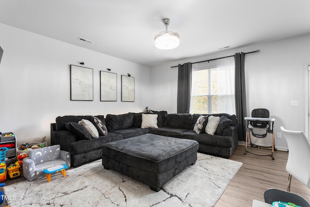 living room with wood finished floors and visible vents