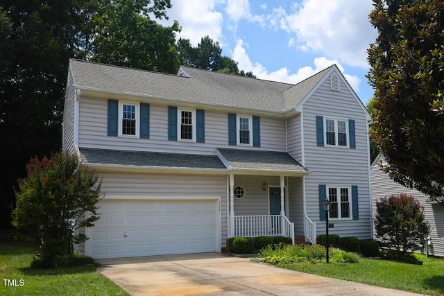 2528 Beech Gap Ct, Raleigh, NC 27603 - traditional-style house with covered porch, a garage, concrete driveway, and roof with shingles