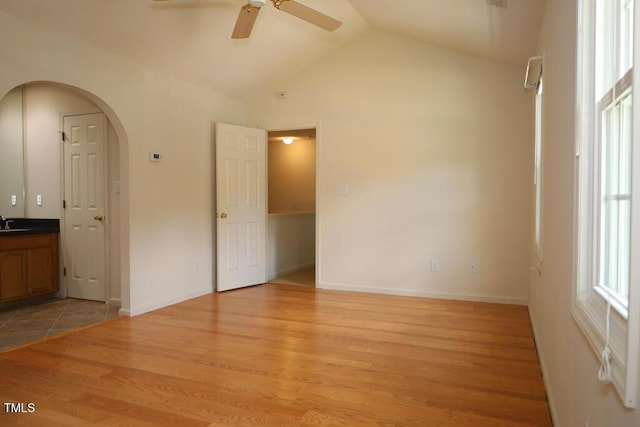 2528 Beech Gap Ct, Raleigh, NC 27603 - spare room with ceiling fan, light wood-style floors, vaulted ceiling, and arched walkways