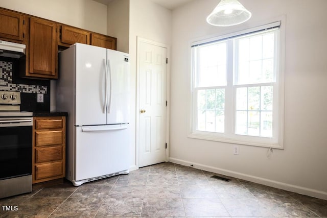 2528 Beech Gap Ct, Raleigh, NC 27603 - kitchen featuring freestanding refrigerator, stainless steel range with electric stovetop, dark countertops, extractor fan, and brown cabinets