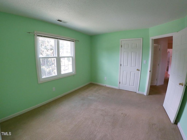 2528 Beech Gap Ct, Raleigh, NC 27603 - unfurnished bedroom featuring carpet floors and a textured ceiling