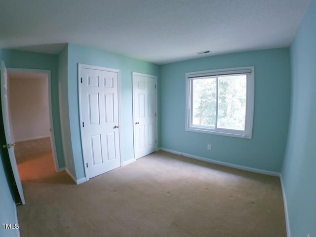 2528 Beech Gap Ct, Raleigh, NC 27603 - unfurnished bedroom with carpet and multiple closets
