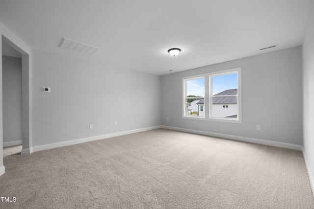 empty room with carpet and baseboards