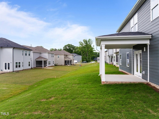 view of green lawn with a residential view