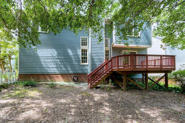 rear view of house with stairs and a deck