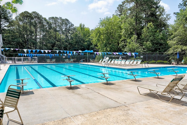 pool featuring fence and a patio