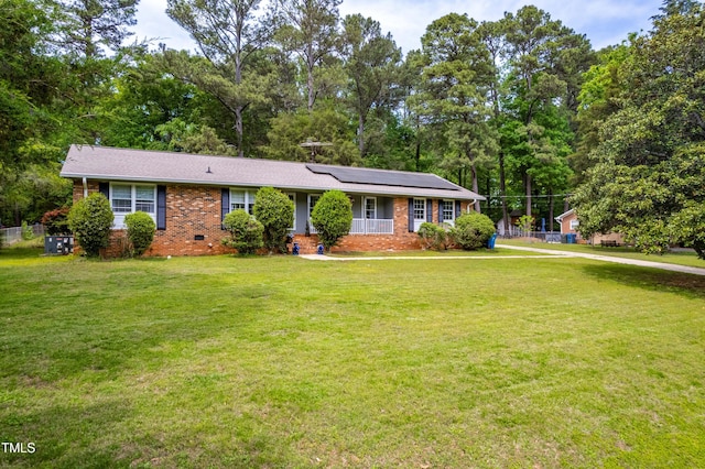 149 Baldwin Dr, Durham, NC 27712 - single story home featuring brick siding, a front yard, crawl space, and solar panels