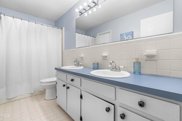 149 Baldwin Dr, Durham, NC 27712 - bathroom featuring tile patterned floors, tile walls, toilet, and a sink