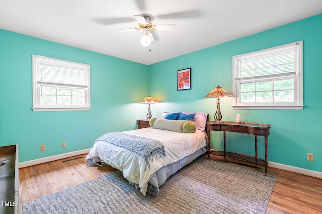 149 Baldwin Dr, Durham, NC 27712 - bedroom featuring baseboards, visible vents, wood finished floors, and multiple windows