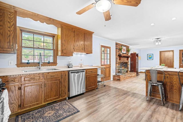 149 Baldwin Dr, Durham, NC 27712 - kitchen featuring stainless steel dishwasher, a sink, brown cabinets, and light wood-style floors