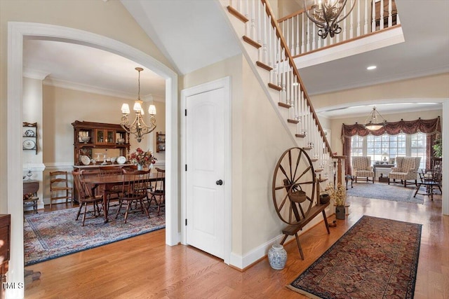 1317 Colonial Club Rd, Wake Forest, NC 27587 - interior space featuring wood finished floors, arched walkways, a chandelier, and stairway