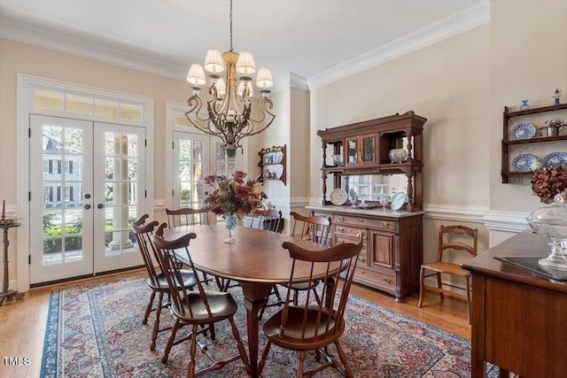 1317 Colonial Club Rd, Wake Forest, NC 27587 - dining space with crown molding, french doors, a chandelier, and light wood-type flooring