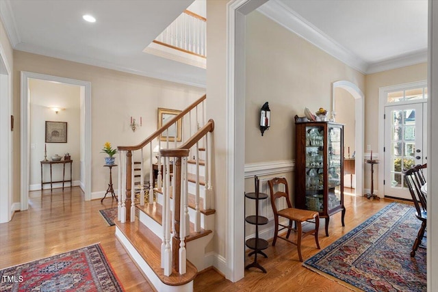 1317 Colonial Club Rd, Wake Forest, NC 27587 - interior space featuring arched walkways, crown molding, wood finished floors, and stairs