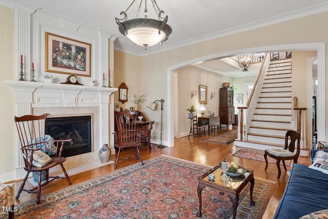 1317 Colonial Club Rd, Wake Forest, NC 27587 - living area with arched walkways, baseboards, wood finished floors, stairway, and ornamental molding