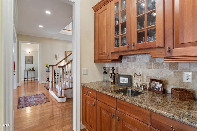 1317 Colonial Club Rd, Wake Forest, NC 27587 - interior space with tasteful backsplash, stairs, light wood finished floors, a sink, and wet bar