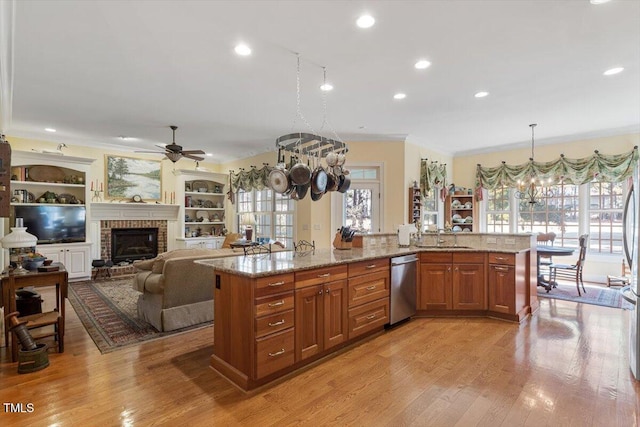 1317 Colonial Club Rd, Wake Forest, NC 27587 - kitchen with light stone countertops, stainless steel dishwasher, brown cabinets, and ornamental molding