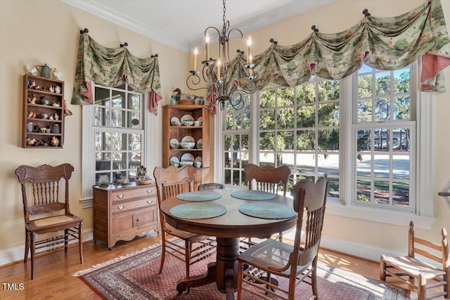 1317 Colonial Club Rd, Wake Forest, NC 27587 - dining area featuring baseboards, an inviting chandelier, light wood finished floors, and crown molding