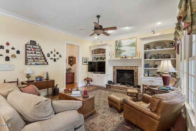 1317 Colonial Club Rd, Wake Forest, NC 27587 - living area with crown molding, ceiling fan, a brick fireplace, and baseboards