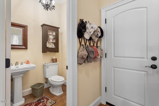 1317 Colonial Club Rd, Wake Forest, NC 27587 - half bath with baseboards, wood finished floors, a sink, and toilet