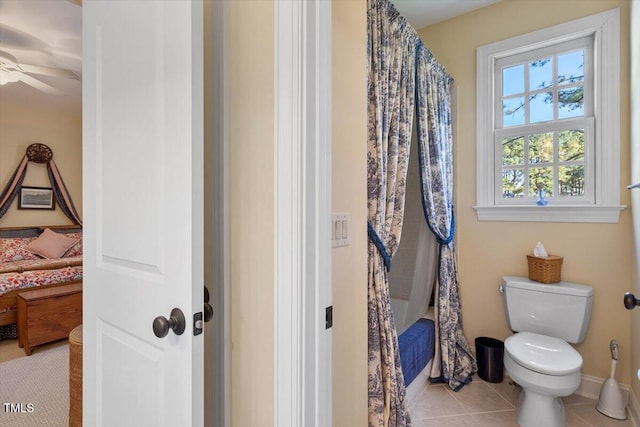 1317 Colonial Club Rd, Wake Forest, NC 27587 - full bathroom with tile patterned flooring, shower / bath combination with curtain, toilet, a ceiling fan, and baseboards
