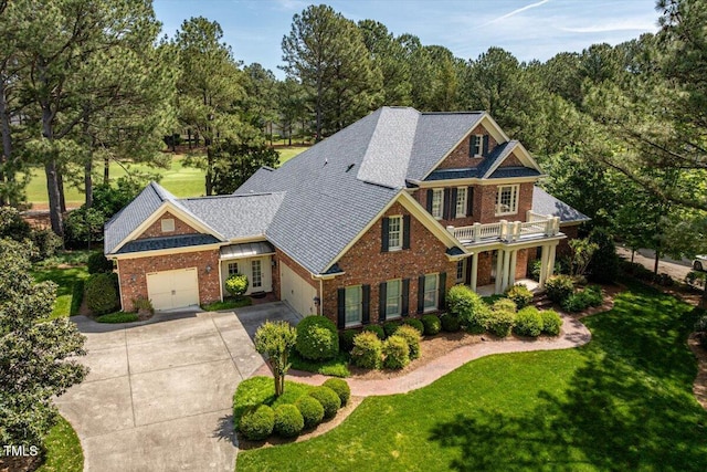 1317 Colonial Club Rd, Wake Forest, NC 27587 - craftsman-style house with brick siding, a front lawn, a balcony, and driveway
