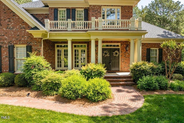 1317 Colonial Club Rd, Wake Forest, NC 27587 - doorway to property featuring a shingled roof, a balcony, french doors, and brick siding