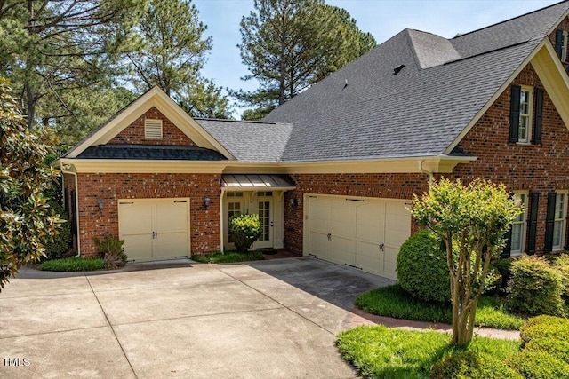 1317 Colonial Club Rd, Wake Forest, NC 27587 - view of front of property featuring brick siding, an attached garage, concrete driveway, and roof with shingles
