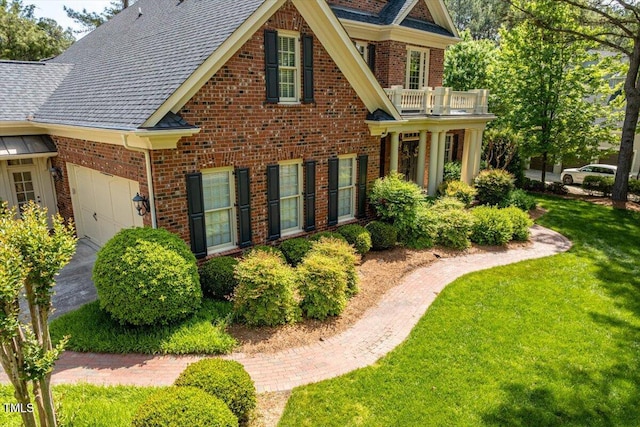 1317 Colonial Club Rd, Wake Forest, NC 27587 - view of property exterior with brick siding, a lawn, an attached garage, and a balcony