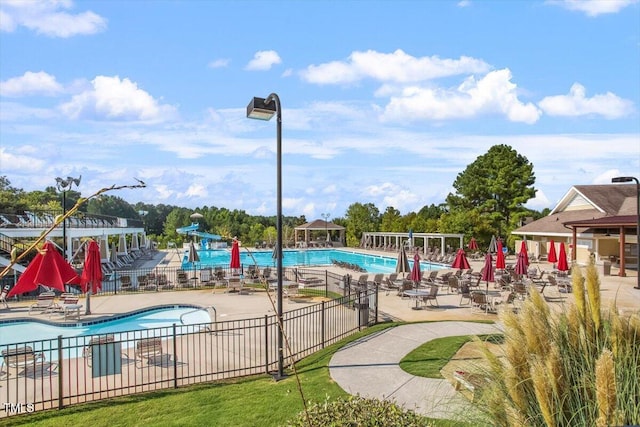 1317 Colonial Club Rd, Wake Forest, NC 27587 - community pool featuring a patio area, a water slide, and fence