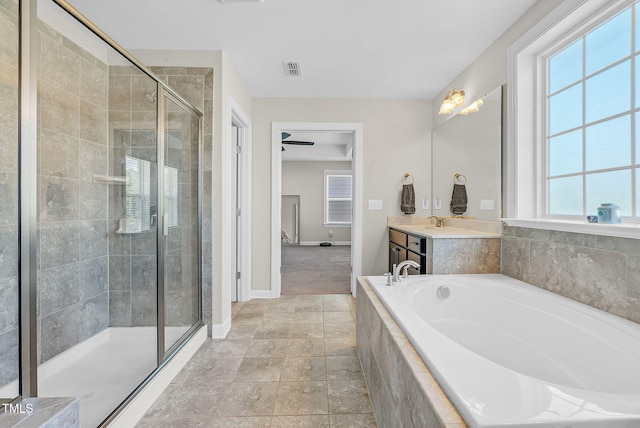 bathroom with a shower stall, visible vents, baseboards, a garden tub, and vanity