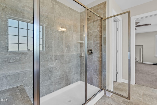 full bath featuring baseboards and a shower stall