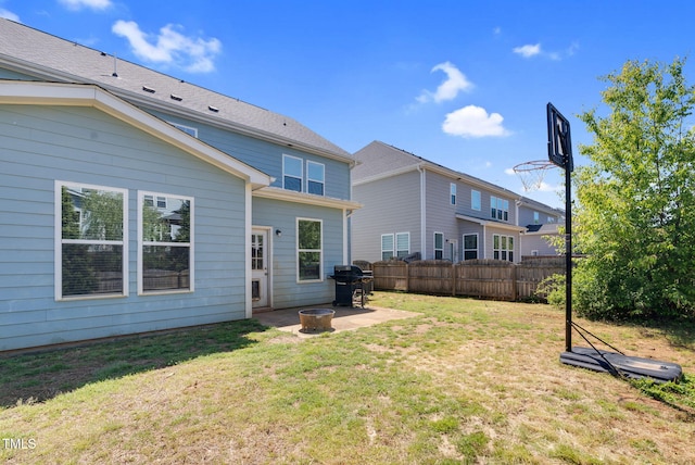 back of house with a patio, a lawn, and fence