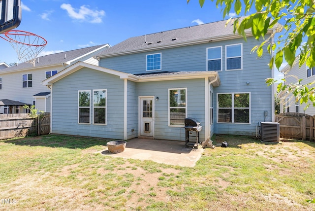 back of house with a lawn, central AC unit, a patio, and a fenced backyard