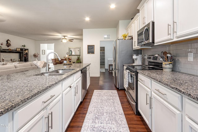 46 S Great White Way, Clayton, NC 27527 - kitchen with a sink, stainless steel appliances, visible vents, white cabinets, and dark wood-style floors