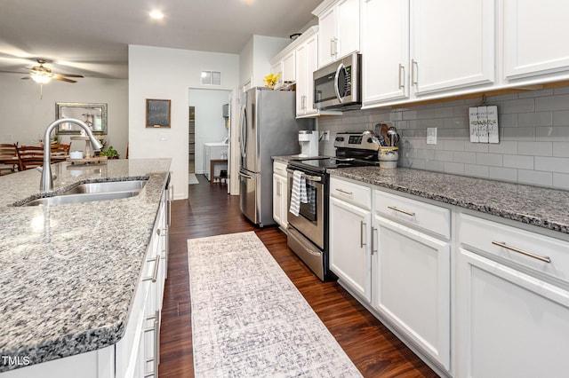 46 S Great White Way, Clayton, NC 27527 - kitchen with a sink, tasteful backsplash, white cabinetry, a ceiling fan, and appliances with stainless steel finishes